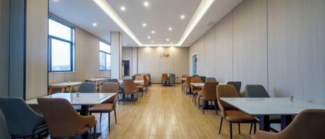 A conference room with tables and chairs arranged for meetings.