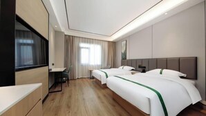 A hotel room with two beds, a desk, a chair, and a TV. - GreenTree Inn Nanshan Development Zone Wannan Chuancang Xian (Ningguo)