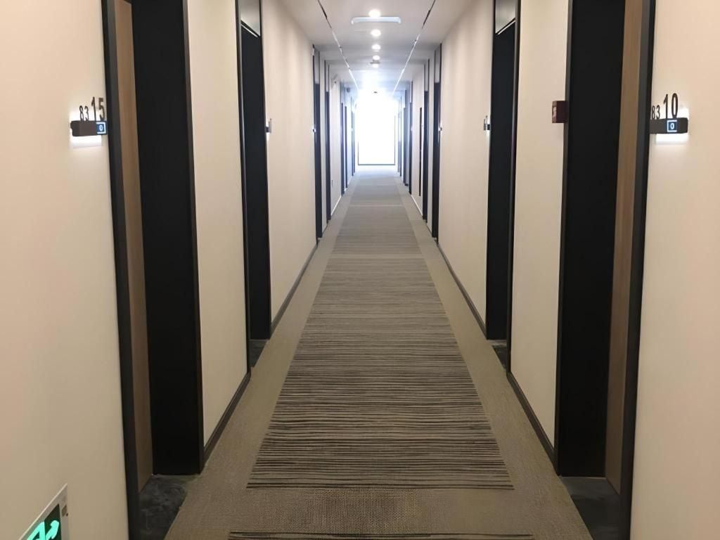 A hotel corridor with doors numbered 8315 and 8310, leading to rooms.