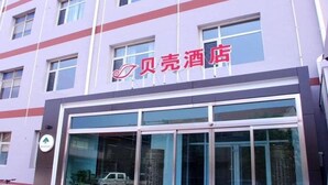 A hotel with a modern facade, large windows, and a prominent sign. - Shell Cangzhou Nanpi County Hospital of Traditional Chinese Medicine Hotel (Cangzhou)