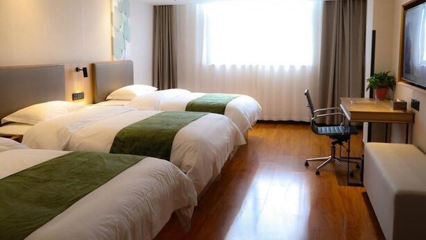 A hotel room with two beds, a desk, a chair, and a large window with curtains. - Greentree Inn Xi an Baqiao District Hongqing Business Hotel (Xi'an)