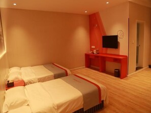 A hotel room with two beds, a desk, a TV, and a red accent wall. - Shell Hebi Qi County Qi River Road Hotel (Hebi)