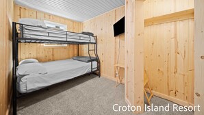 A bunk bed room with wooden walls and a small desk. - River Front Home with Amazing views and a shared private island! (Newaygo)