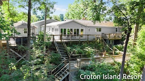 A resort with multiple buildings surrounded by trees. - River Front Home with Amazing views and a shared private island! (Newaygo)