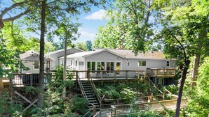 A resort with multiple buildings surrounded by trees. - River Front Home with Amazing views and a shared private island! (Newaygo)