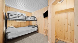 A bunk bed room with wooden walls and a small desk. - River Front Home with Amazing views and a shared private island! (Newaygo)