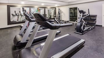 A gym with treadmills, ellipticals, and weight machines.