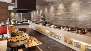 A buffet area with various food items, a coffee station, and a decorative plant. - Wyndham Chandigarh Mohali (Mohali)