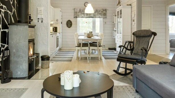 A spacious living room with a fireplace, a dining area, and a cozy seating area.