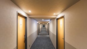 A hotel hallway with doors numbered 309 and 321, carpeted flooring, and recessed lighting.