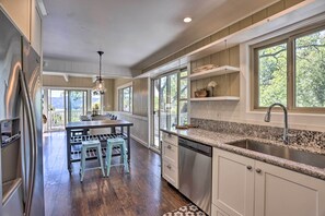 Enjoy cooking in this well-equipped kitchen with a central island, dishwasher, and stainless steel sink.