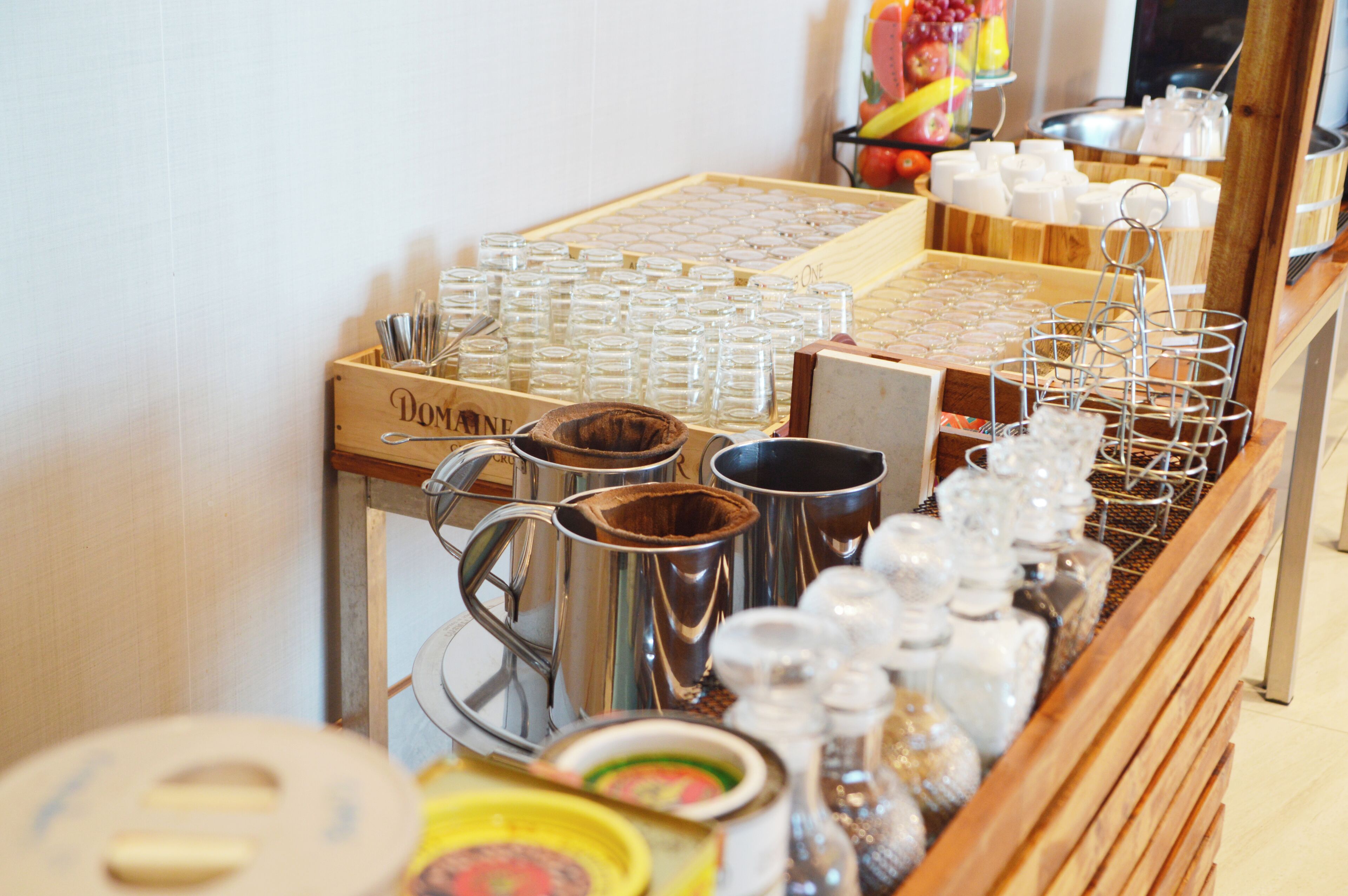 A display of various kitchenware items including glassware, metal containers, and utensils.