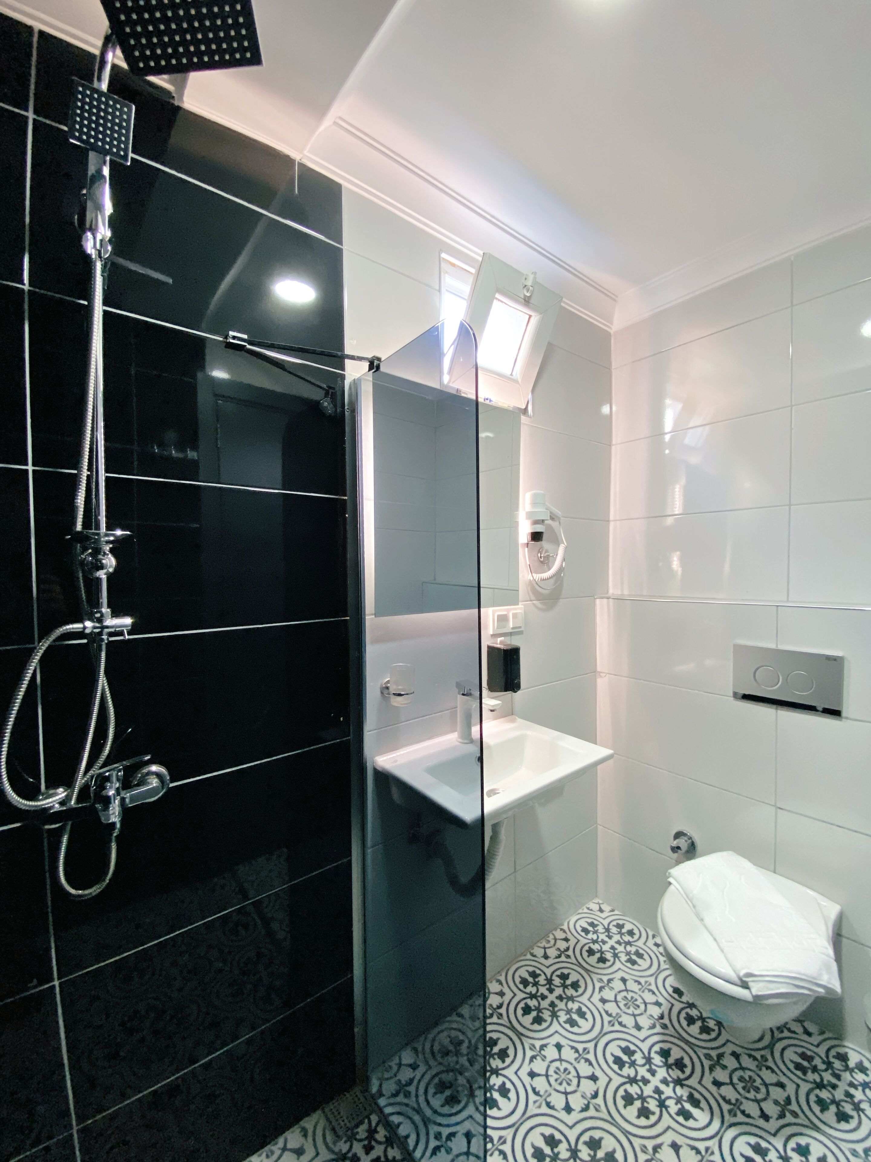 shower, hair dryer, slippers, towels