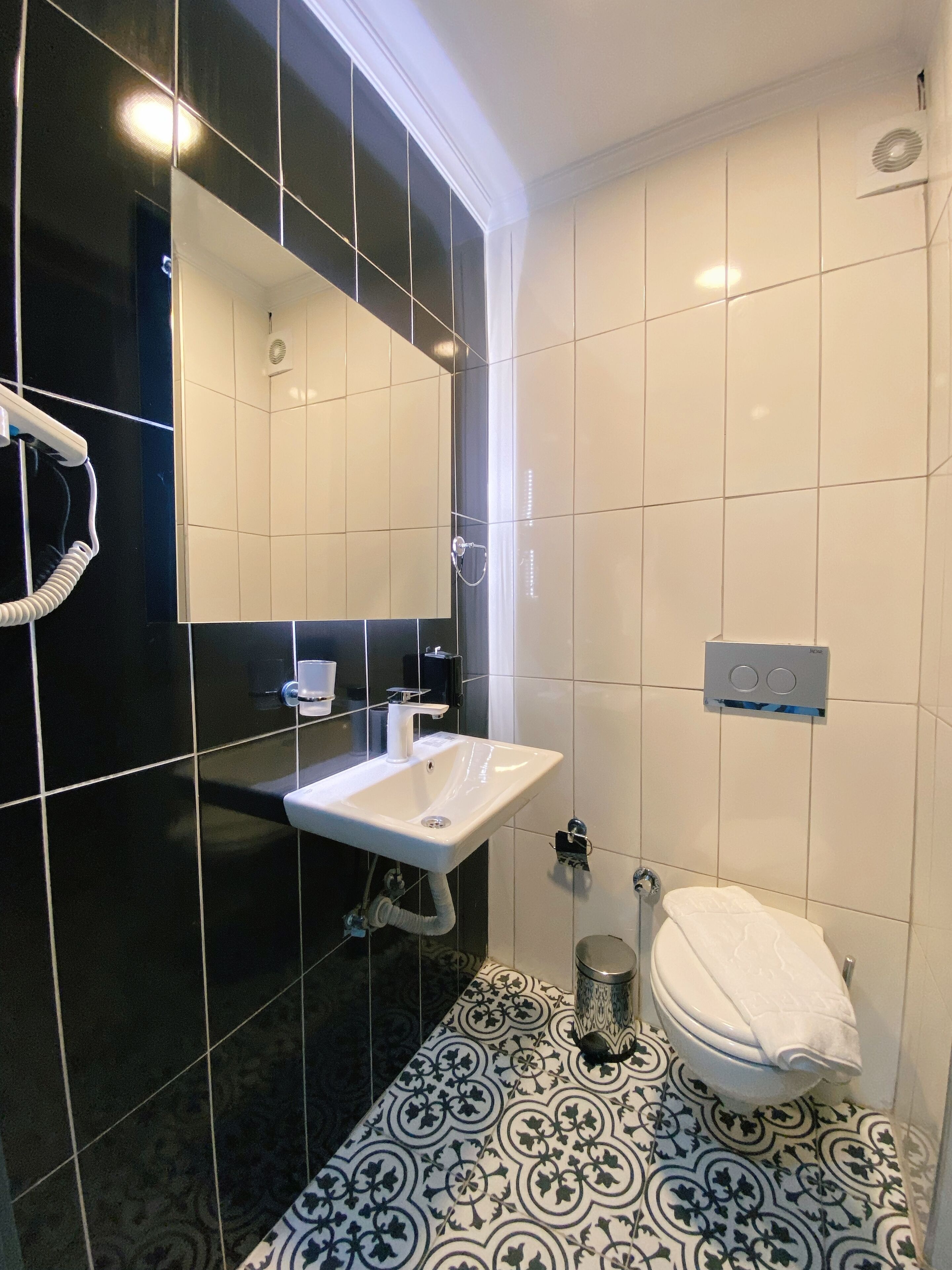 shower, hair dryer, slippers, towels