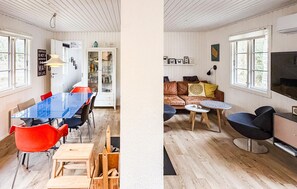Un intérieur moderne comprenant un coin repas, un ensemble de canapés et un téléviseur.