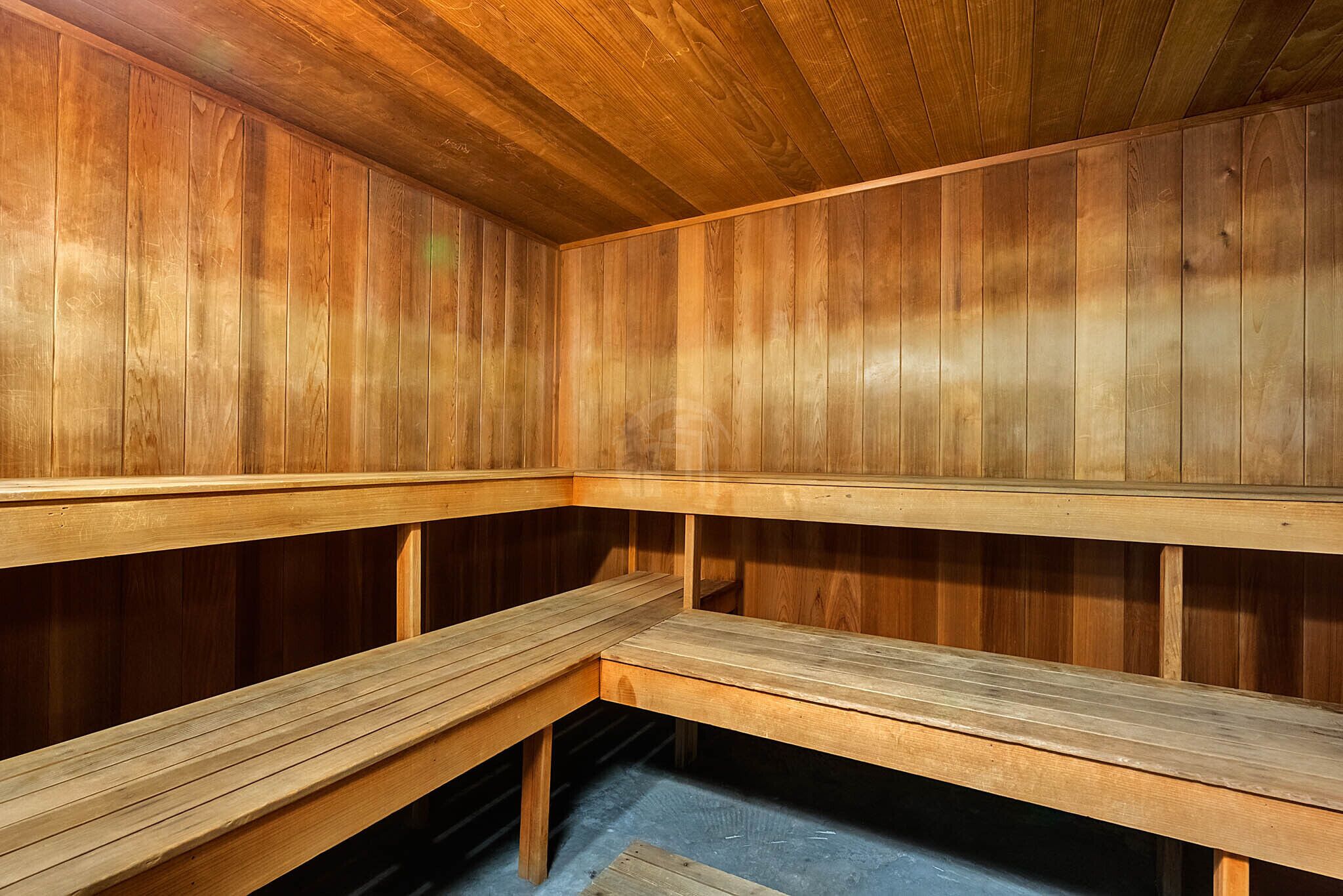 A sauna with wooden benches and walls.