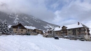 Surrounded by snow-covered mountains, this charming village offers a serene mountain backdrop.