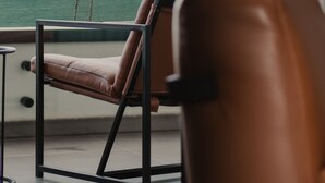 A chair with a view of the sea through a window. - Maritim Marina Bay Luxury Resort (Vlorë)