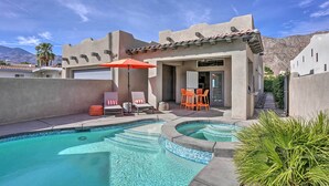 A pool area with a curved design, outdoor seating, and a mountain backdrop. - Lavish 3 BR La Quinta Oasis < 2 Mi to Old Town (La Quinta)