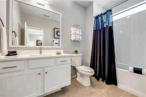 Bathtub, hair dryer, towels, shampoo