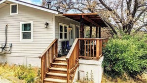A two-story house with a wooden staircase leading to a porch. - # 3. Howling Wolf's Lair - Studio W/ Fireplace (Pet Free) (Santa Ysabel)