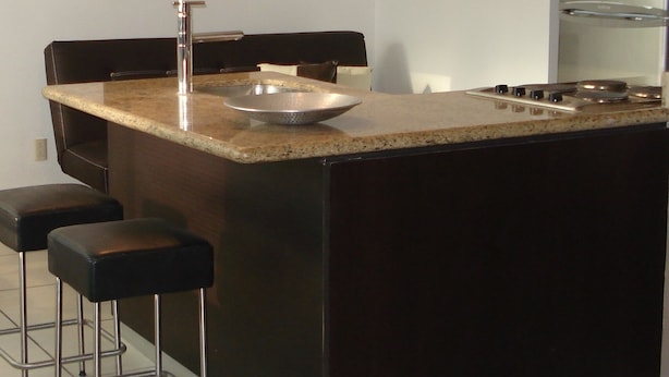 A modern kitchen with a central island, bar stools, stainless steel appliances, and pendant lighting. - Central located luxury studio, steps to all bars & restaurants,  (Puerto Vallarta)