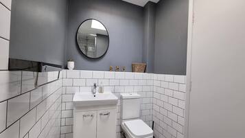 Shower, rainfall showerhead, hair dryer, towels