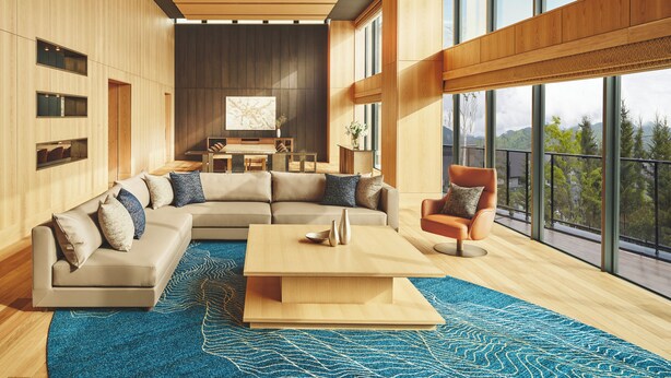 A modern living room with a sectional sofa, a coffee table, and a view of the outdoors through large windows. - Intercontinental Appi Kogen Resort by IHG (Hachimantai)