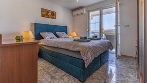 A bedroom with a bed, a desk, a chair, a window, and an air conditioning unit. - Holiday Home in Medulin with Seaview, Terrace, Air condition, WIFI (3486-4) (Medulin)