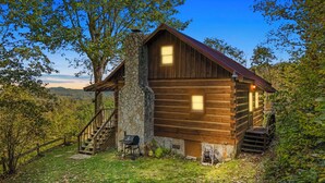 A rustic cabin with a stone chimney, wooden exterior, and a porch with a staircase. - Stunning Mountain Views!!! Secluded Log Cabin with Hot Tub near West Jefferson  (Lansing)