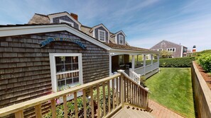 A house with a sign reading "THE BOUNTY" and a covered porch with a wooden railing.