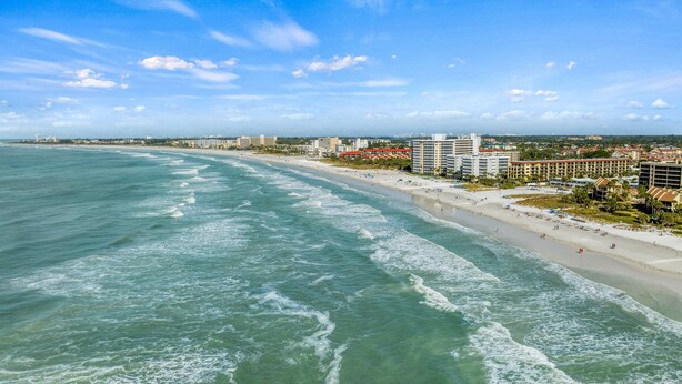 A coastal cityscape with a wide beach, beachfront hotels, and ocean waves. - Sandy Rocks | Ultimate Bundle: 2 Private Pet Friendly Homes, 2 Private Heated Pools, Walk to Beach! (Siesta Key)