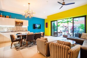 A modern living space with a kitchen, dining area, and seating area.