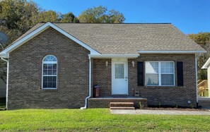 Stroll up to the charming single-story house with a gabled roof and inviting front porch.