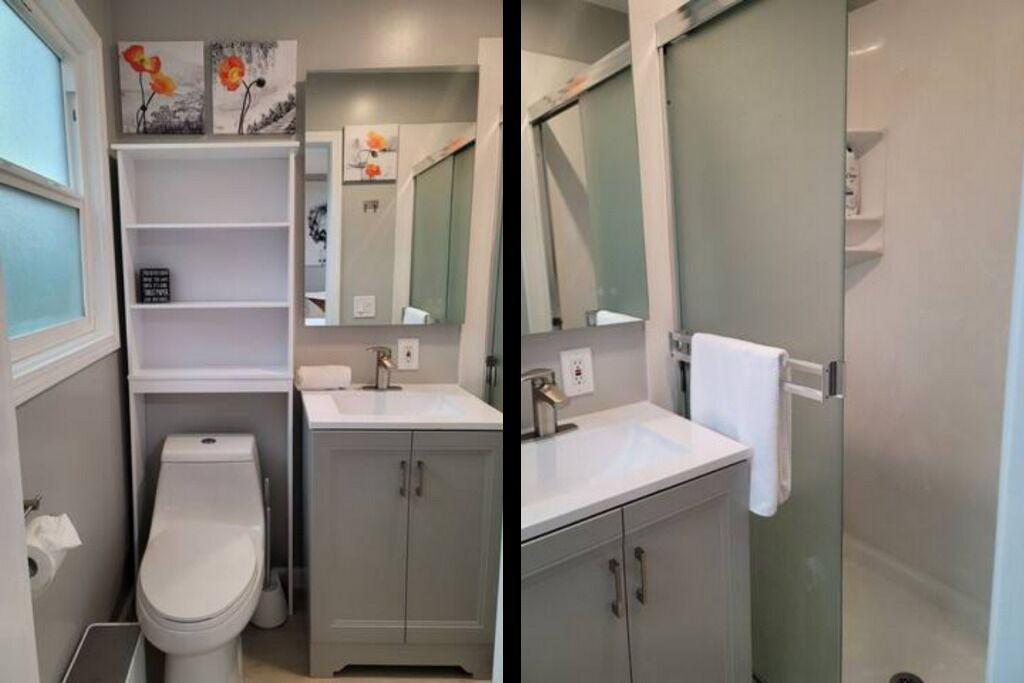 A bathroom with a toilet, a sink, and a shower area.