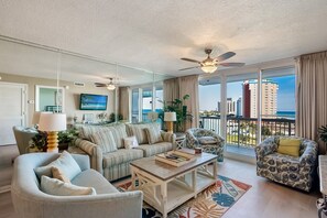 Relax in this stylish living room with a city skyline view and ocean views from the balcony.