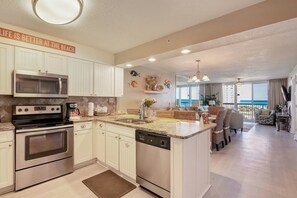 Enjoy cooking in the well-equipped kitchen with a large island and stainless steel appliances.