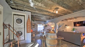 A laundry room with a washing machine, a drying rack, and a wooden barrel. - Eclectic Asheville Abode w/ Backyard Oasis! (Asheville)