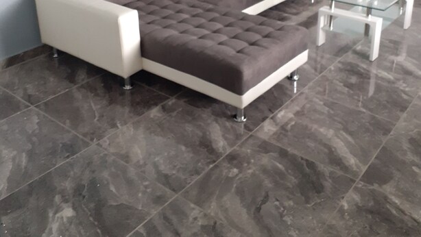 A modern living room with a grey sofa, a glass coffee table, and a white armchair. - House terrace beach riviere (pointe noire)