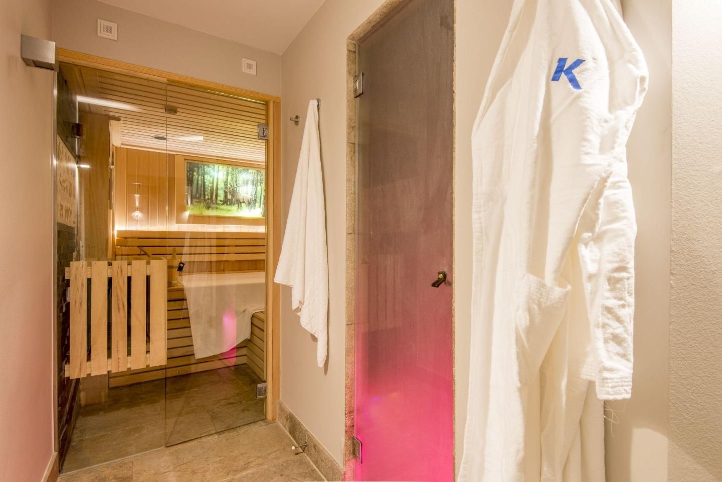 A hallway with a wooden door, a radiator, and a towel hanging on the wall.