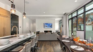 A modern kitchen with a long island, bar seating, and a large window with a view. - Unbeatable Location, Hot Tub, Luxury Amenities & Year-Round Recreation! Park City Parkite 35 (Park City)