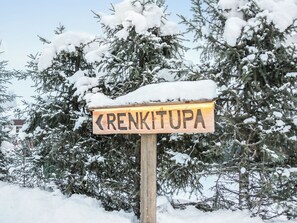 A wooden sign with the name 'RENKITUPA' in capital letters, surrounded by snow-covered trees. - Renkitupa by Interhome (Rovaniemi)