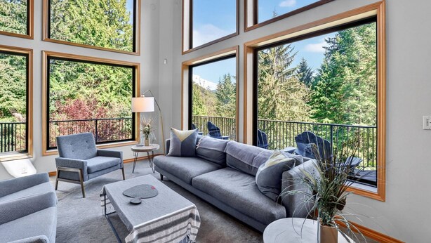 A spacious balcony with a sofa, chairs, and a coffee table.