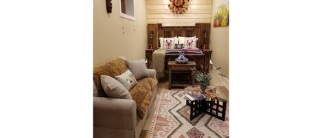 A cozy living room with a sofa, a coffee table, and a rug.