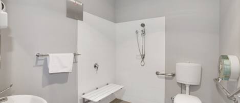 A modern bathroom with a toilet, bidet, and sink.