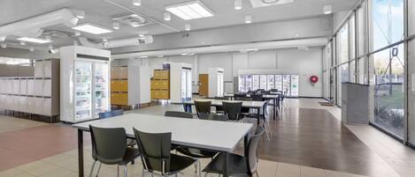 A spacious cafeteria with high ceilings, ample natural light, and modern furniture.