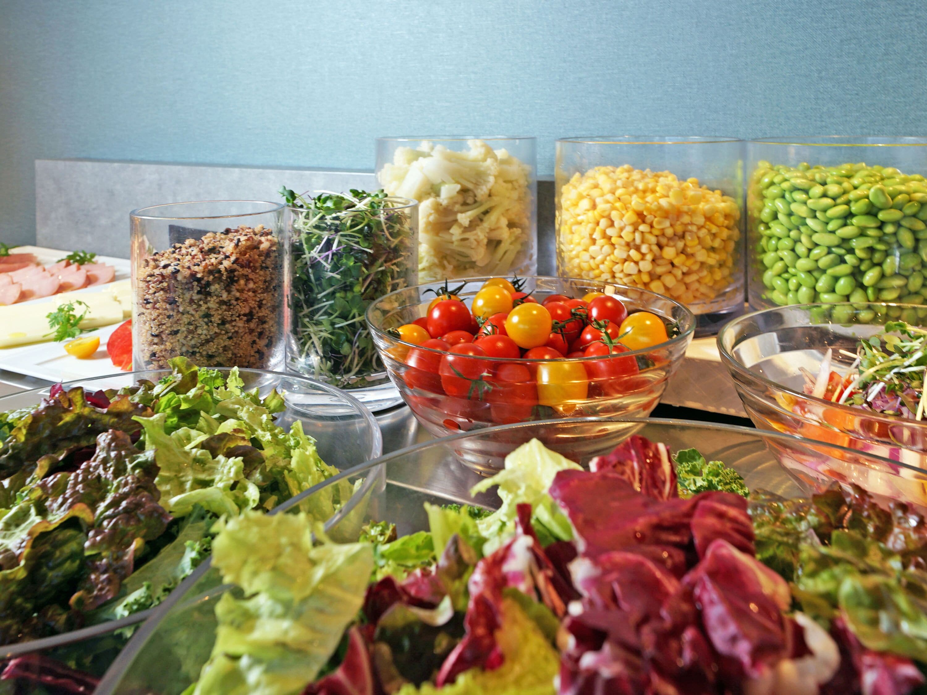 A buffet with various food items including salads, grains, and vegetables.