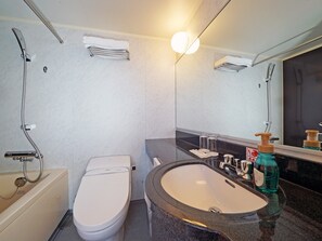 Combined shower/tub, free toiletries, hair dryer, slippers