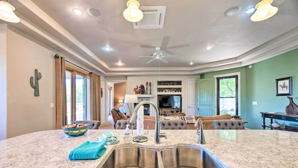 A kitchen with a large island, double sink, and a ceiling fan. - 'Doc's Retreat' in Ruidoso Downs w/ Mtn Views (Ruidoso Downs)