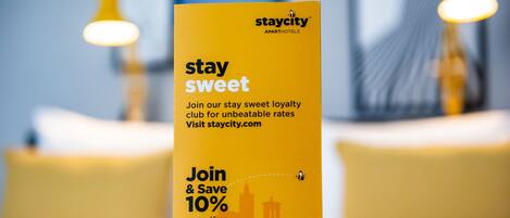 A promotional sign for Staycity's loyalty program, highlighting a 10% savings offer.